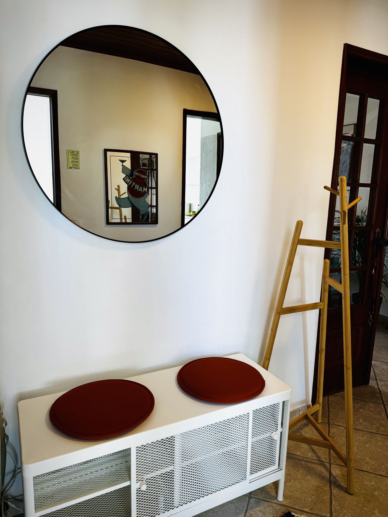 Entry bench and round mirror in the Salted House hallway