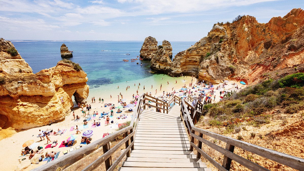 Wooden stairs leading down to Praia do Camilo